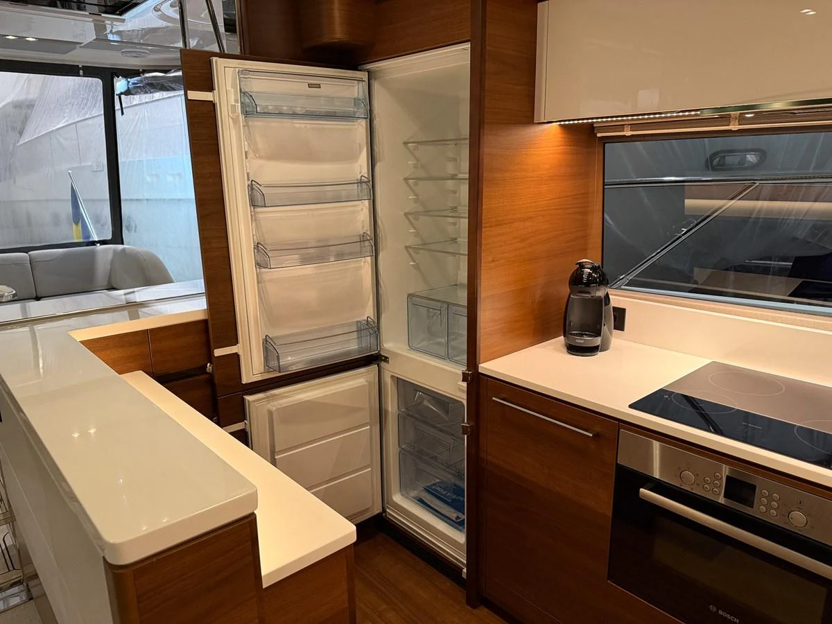 The galley features modern appliances and sleek cabinetry, creating a functional and stylish space for meal preparation. aboard PRINCESS 70 Yacht for Sale