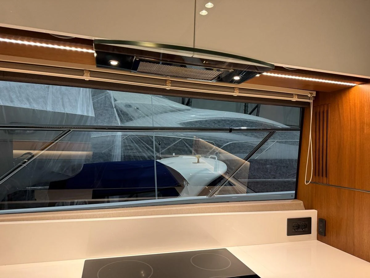 The galley features modern appliances and a large window with a view of the exterior. aboard PRINCESS 70 Yacht for Sale