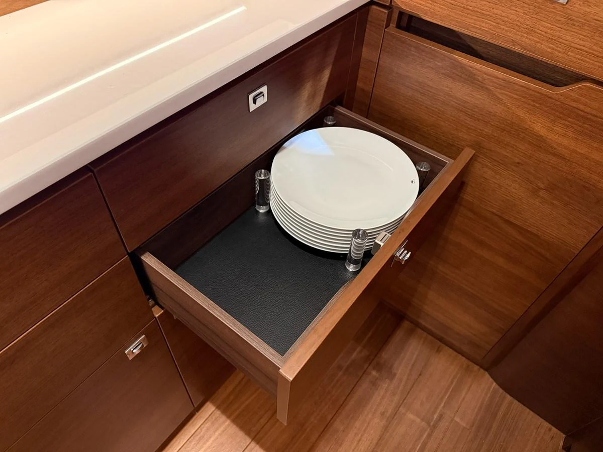 A drawer in the yacht's galley neatly holds a stack of white plates. aboard PRINCESS 70 Yacht for Sale