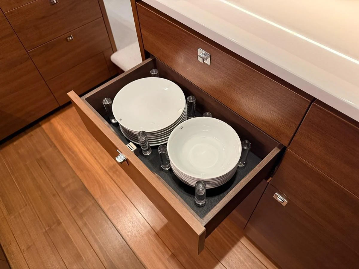 A neatly organized drawer in the galley holds plates securely in place. aboard PRINCESS 70 Yacht for Sale