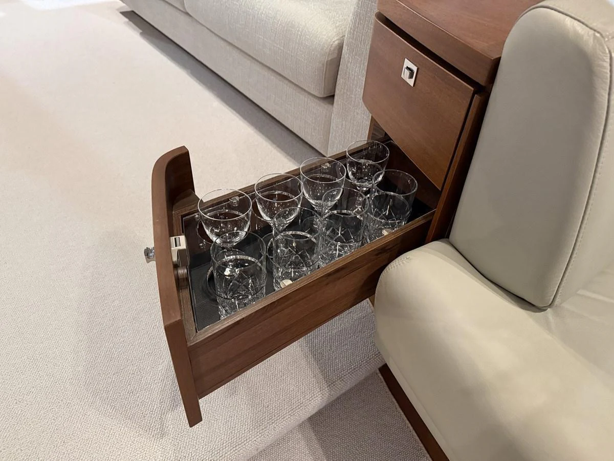 A drawer with neatly arranged glassware, showcasing the yacht's attention to detail and luxury. aboard PRINCESS 70 Yacht for Sale