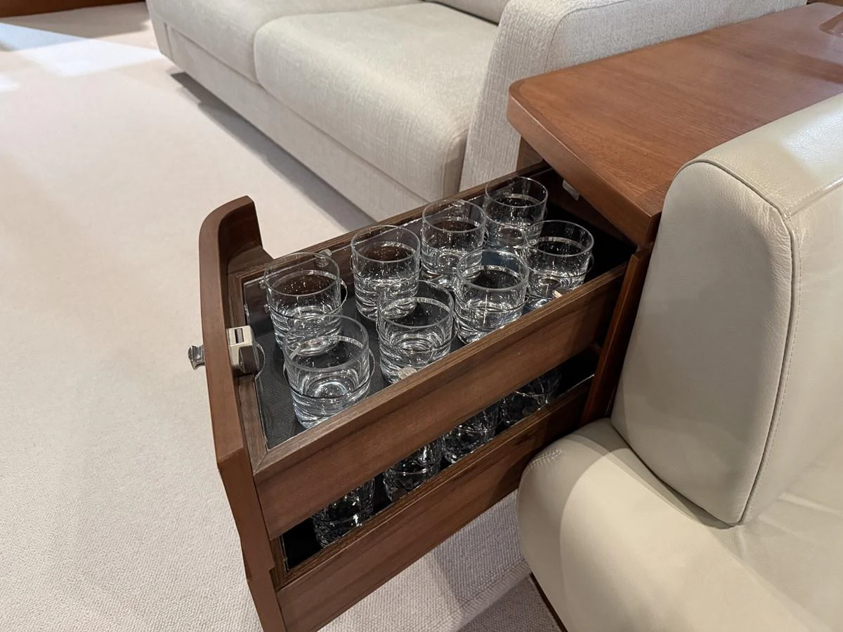 A drawer with neatly arranged glassware, showcasing the yacht's attention to detail and luxury. aboard PRINCESS 70 Yacht for Sale
