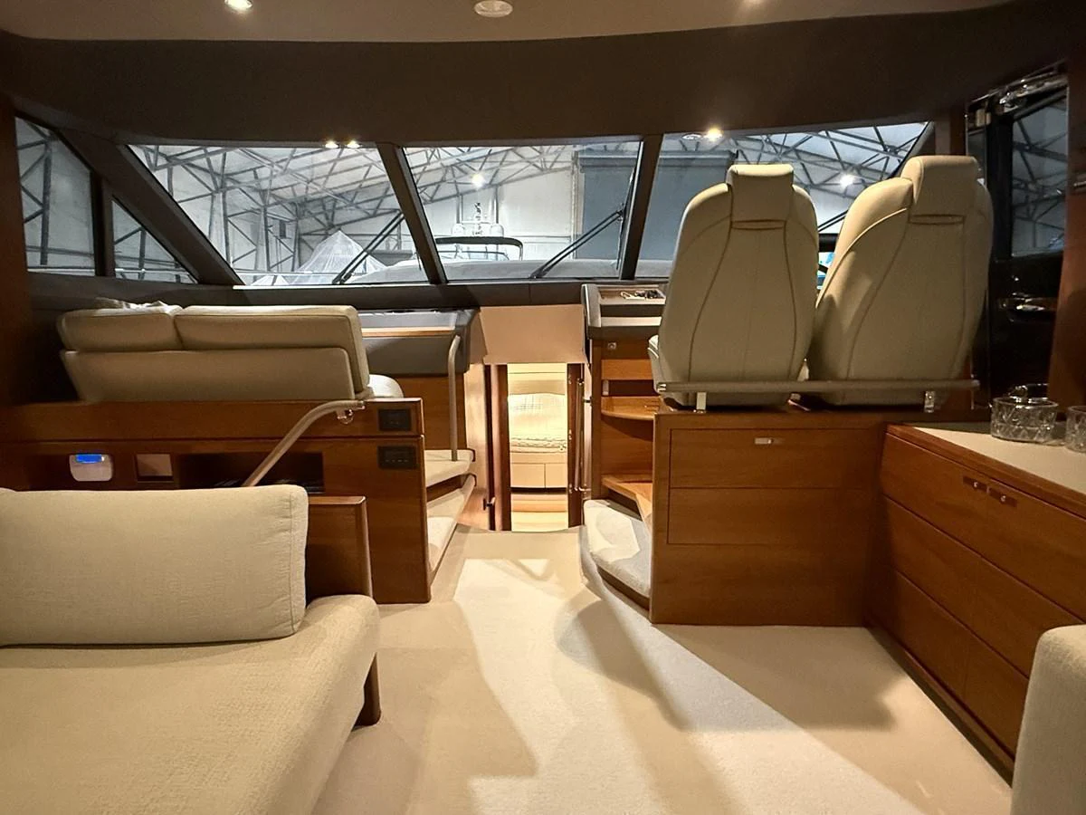 The helm area features modern seating and expansive windows for optimal visibility. aboard PRINCESS 70 Yacht for Sale