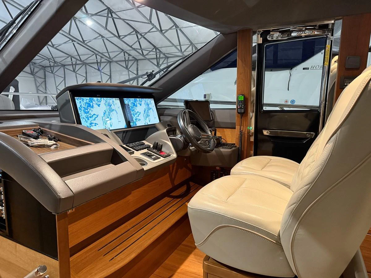 The helm station features modern navigation equipment and comfortable seating. aboard PRINCESS 70 Yacht for Sale