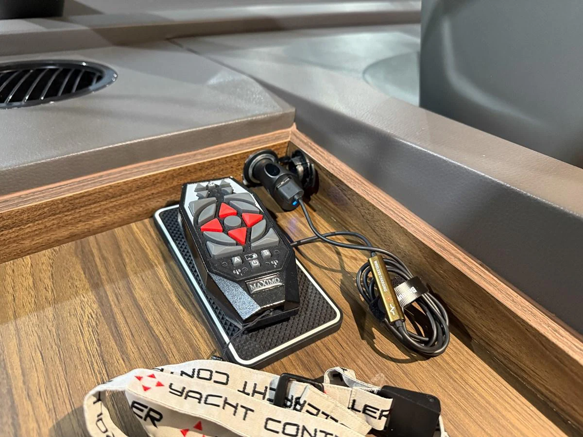 A close-up of a yacht control device and accessories on a wooden surface. aboard PRINCESS 70 Yacht for Sale