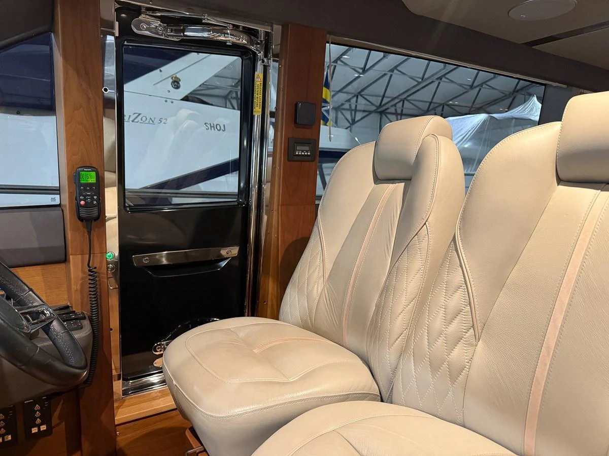 The helm area features plush seating and modern controls, offering a comfortable and stylish command center. aboard PRINCESS 70 Yacht for Sale