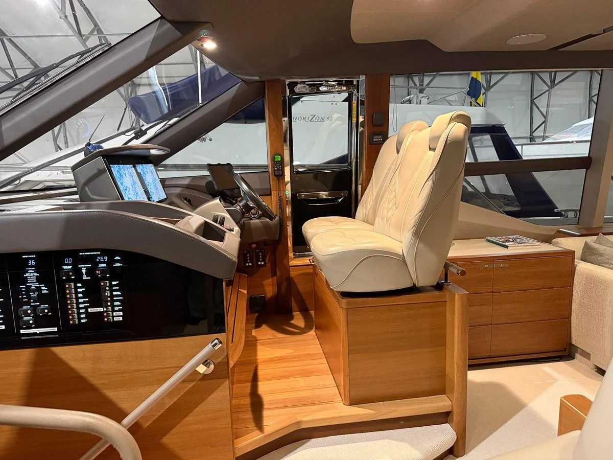 The helm station features luxurious seating and state-of-the-art navigation equipment. aboard PRINCESS 70 Yacht for Sale