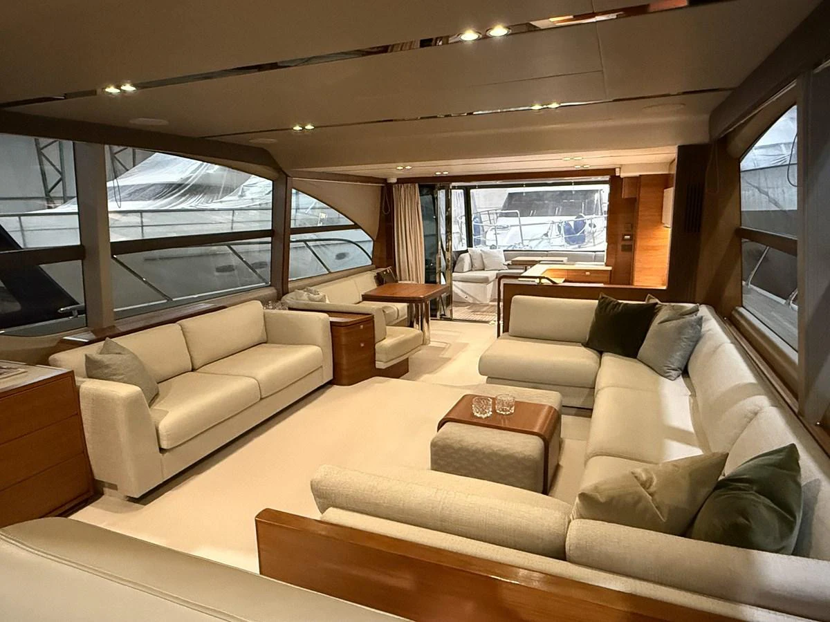 The salon features plush seating and large windows, creating a comfortable and inviting space. aboard PRINCESS 70 Yacht for Sale