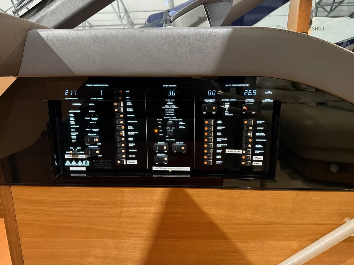 The image showcases the helm's advanced control panel with multiple digital displays and controls. aboard PRINCESS 70 Yacht for Sale