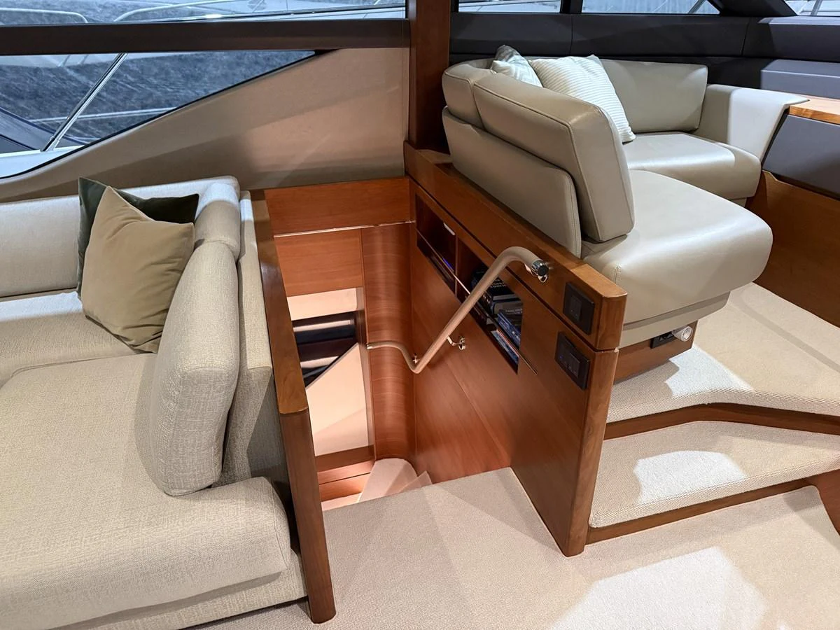 The yacht's salon features comfortable seating and a staircase leading to the lower deck. aboard PRINCESS 70 Yacht for Sale