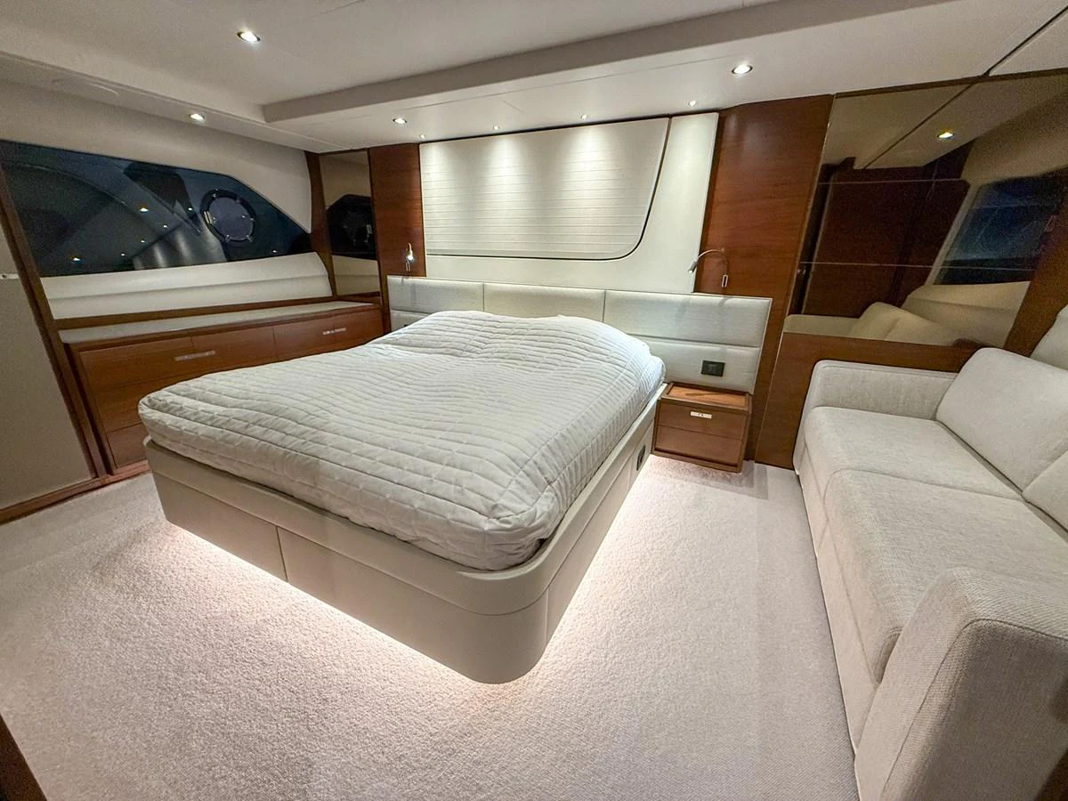 The master stateroom features a luxurious bed with elegant lighting and ample space for relaxation. aboard PRINCESS 70 Yacht for Sale