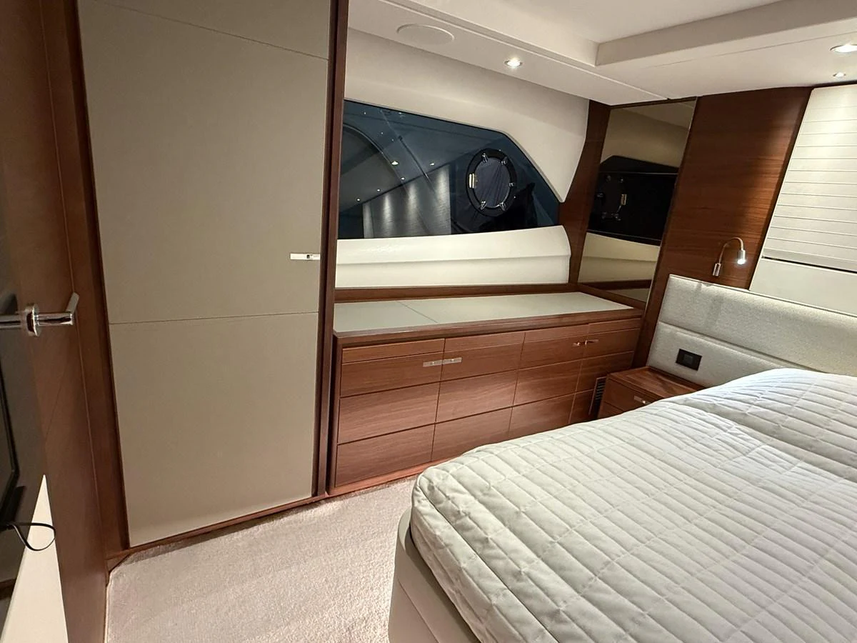 A luxurious stateroom featuring elegant wood finishes and a large bed. aboard PRINCESS 70 Yacht for Sale