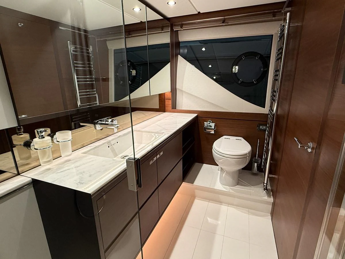 A sleek and modern yacht bathroom with elegant fixtures and ample lighting. aboard PRINCESS 70 Yacht for Sale