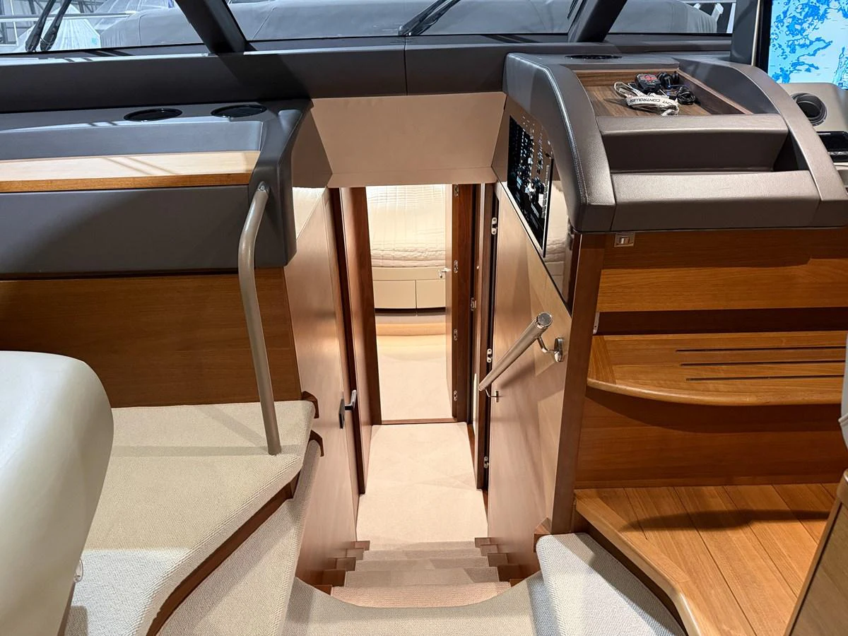 The image showcases the helm area with a view down the stairs to the lower deck. aboard PRINCESS 70 Yacht for Sale
