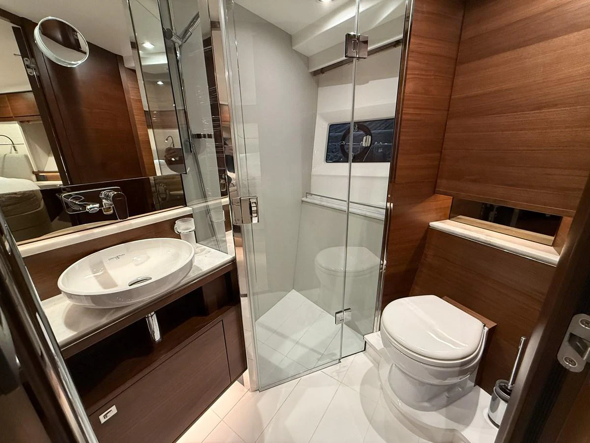 The yacht's bathroom features modern fixtures and elegant wood paneling. aboard PRINCESS 70 Yacht for Sale