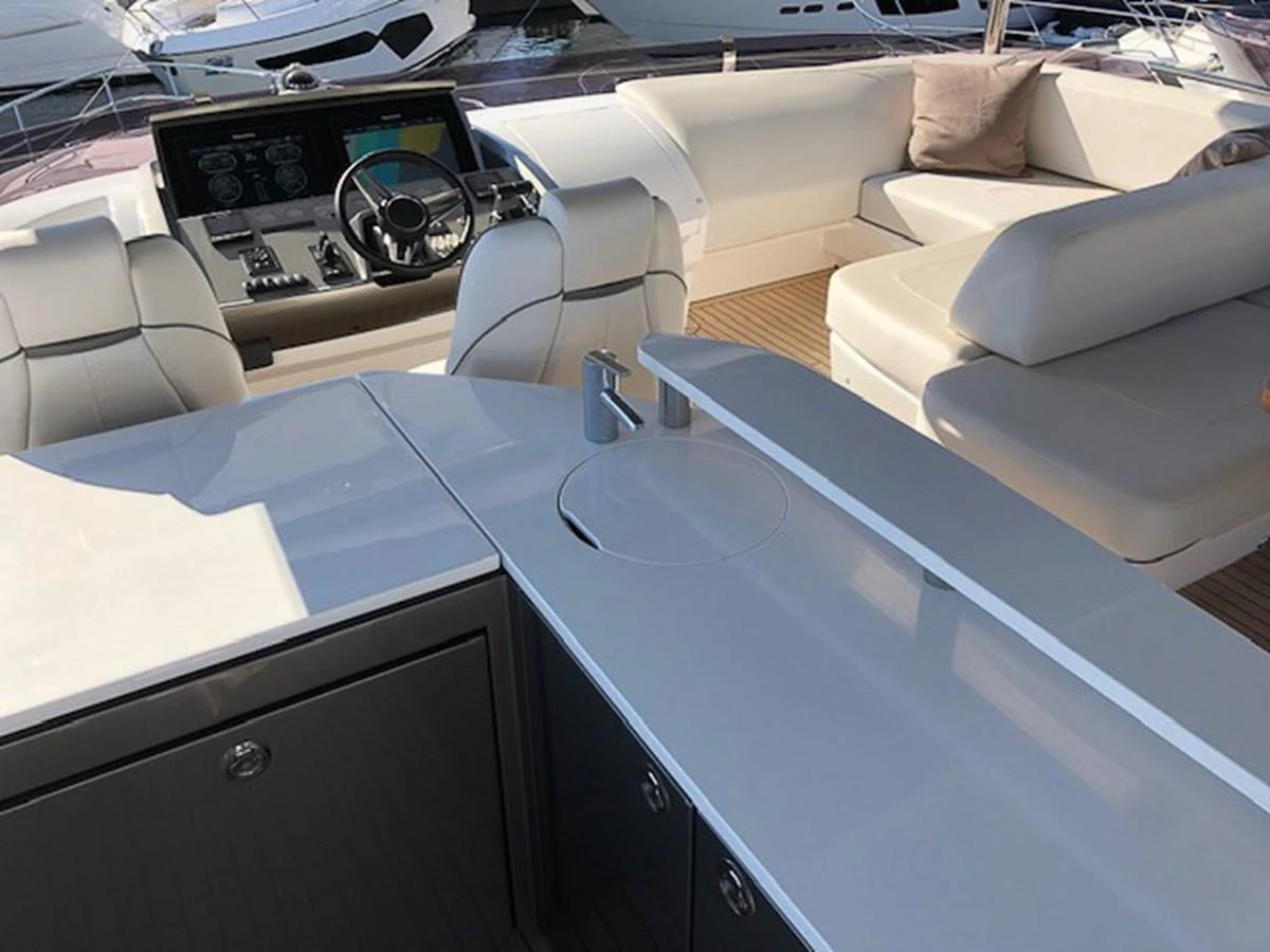 The helm area features comfortable seating and advanced navigation equipment. aboard PRINCESS 70 Yacht for Sale