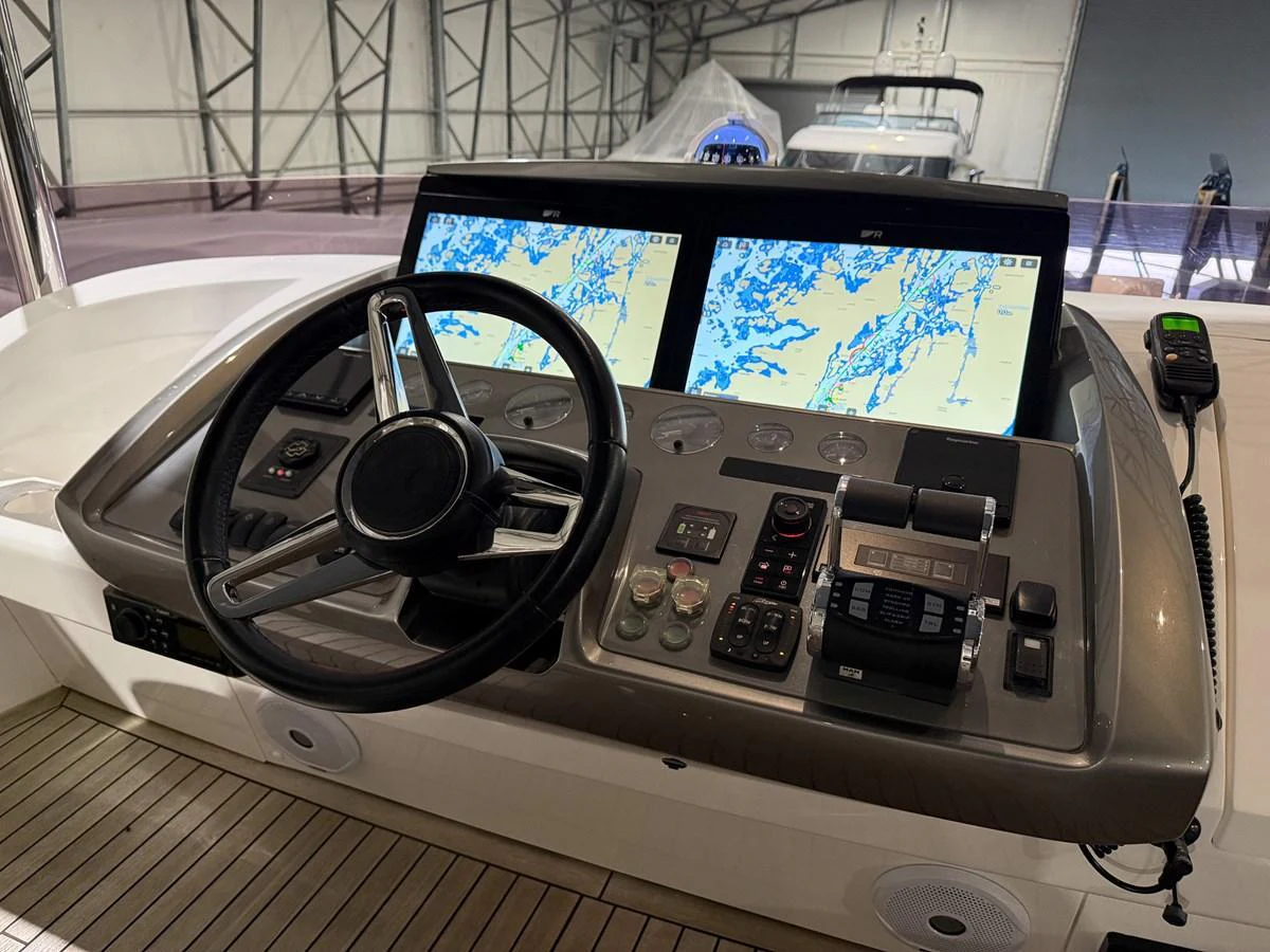 The helm features advanced navigation systems and a sleek steering wheel, ensuring precise control and ease of operation. aboard PRINCESS 70 Yacht for Sale