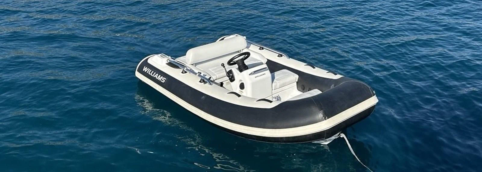 A sleek tender floats on calm blue waters, ready for quick trips to shore. aboard SUNSEEKER 66 MANHATTAN Yacht for Sale