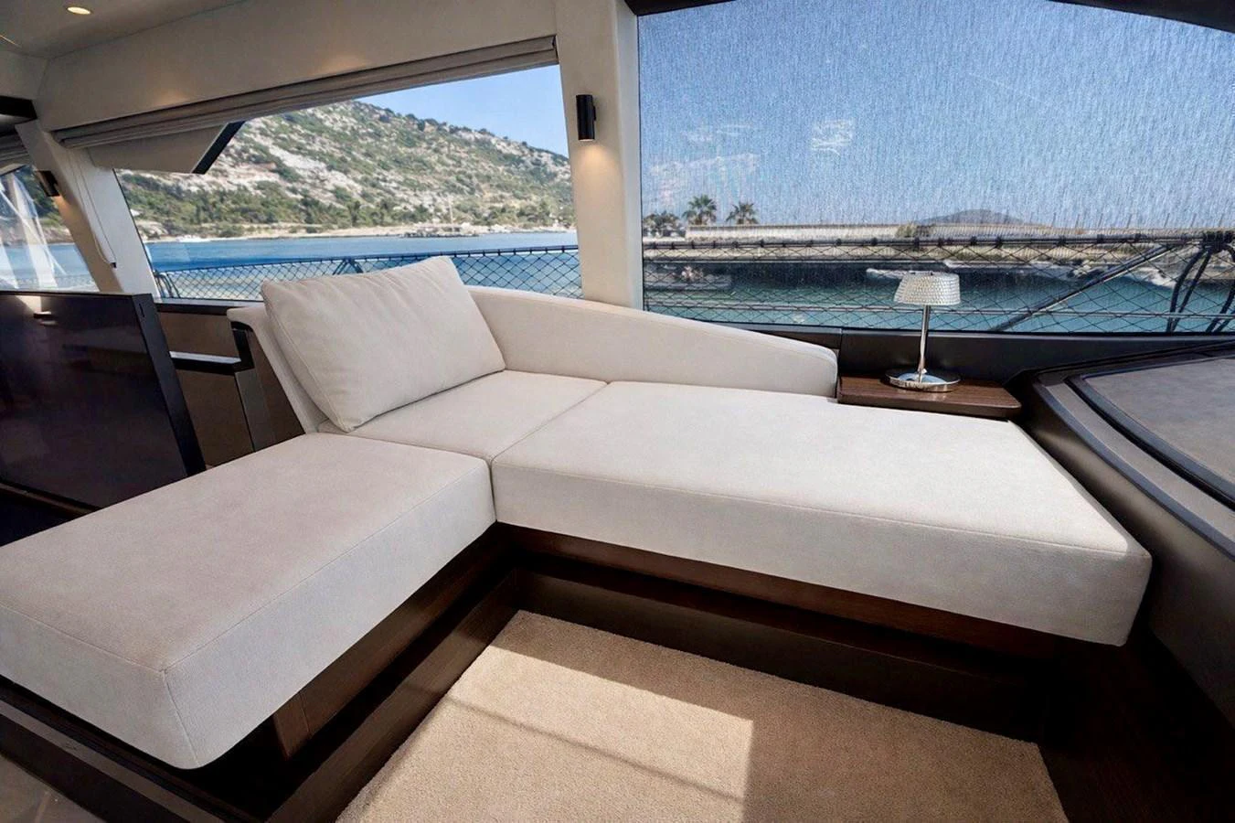 The salon features a comfortable lounging area with large windows offering stunning views of the water. aboard SUNSEEKER 66 MANHATTAN Yacht for Sale