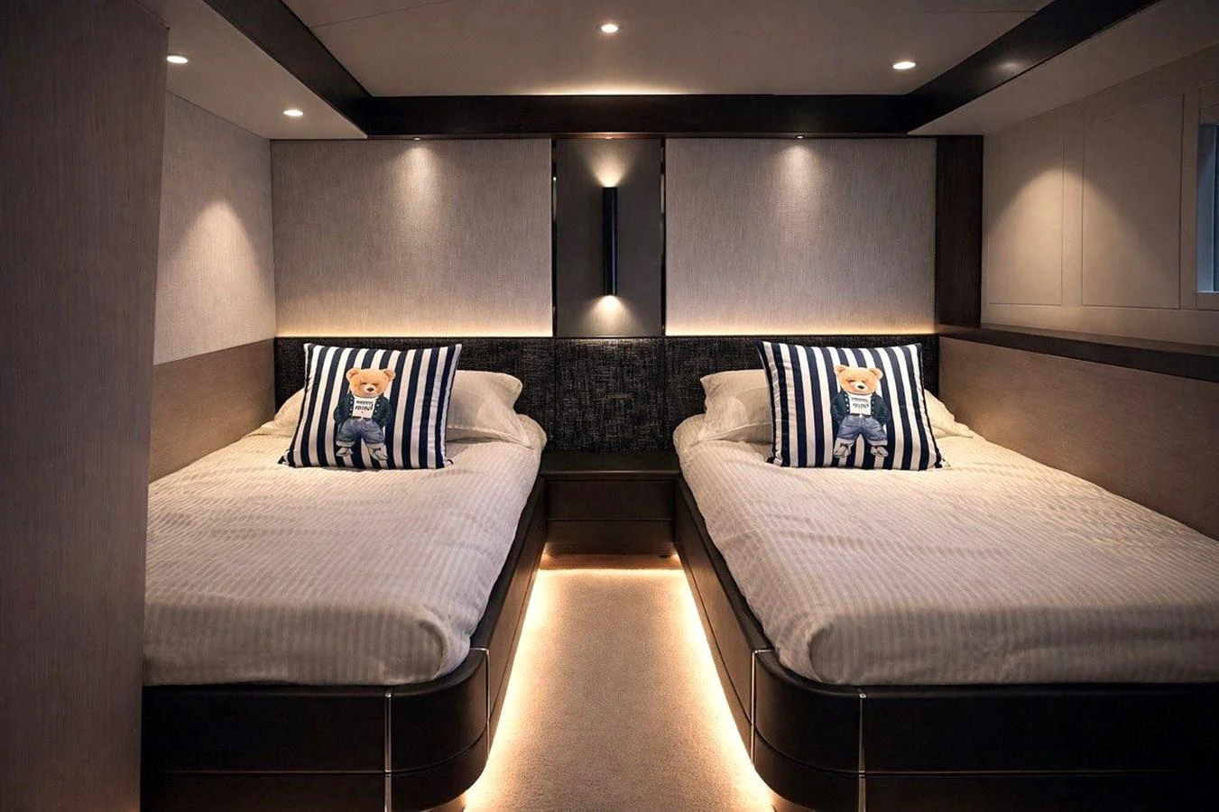 A cozy guest stateroom with twin beds and stylish lighting. aboard SUNSEEKER 66 MANHATTAN Yacht for Sale