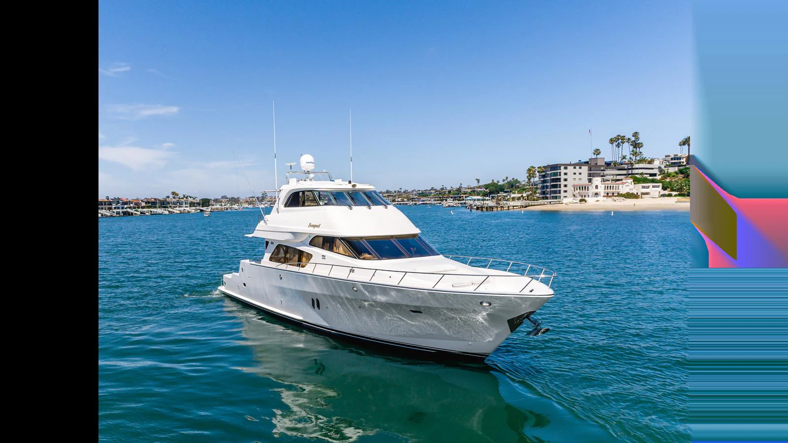 A sleek yacht cruises on calm waters near a coastal town. aboard SEAQUEL Yacht for Sale