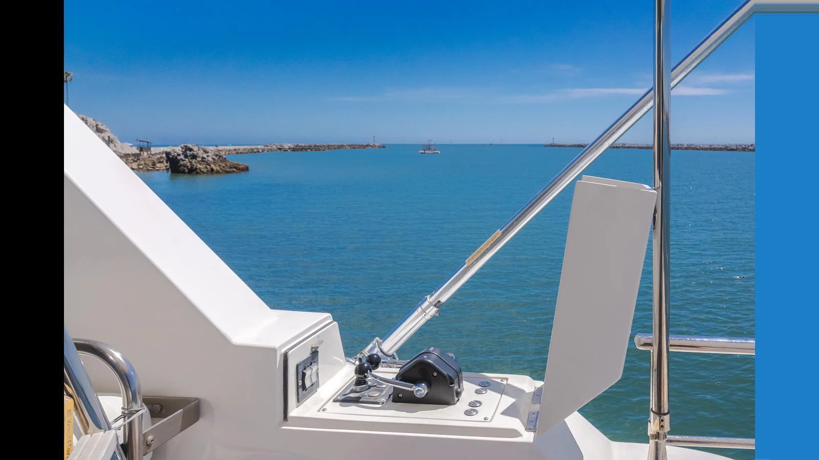 A close-up view of the yacht's control station with a serene ocean backdrop. aboard SEAQUEL Yacht for Sale