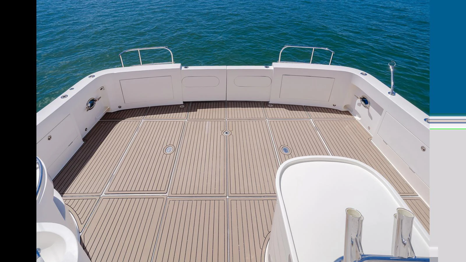 The aft deck offers a spacious area with elegant teak flooring and a view of the serene water. aboard SEAQUEL Yacht for Sale