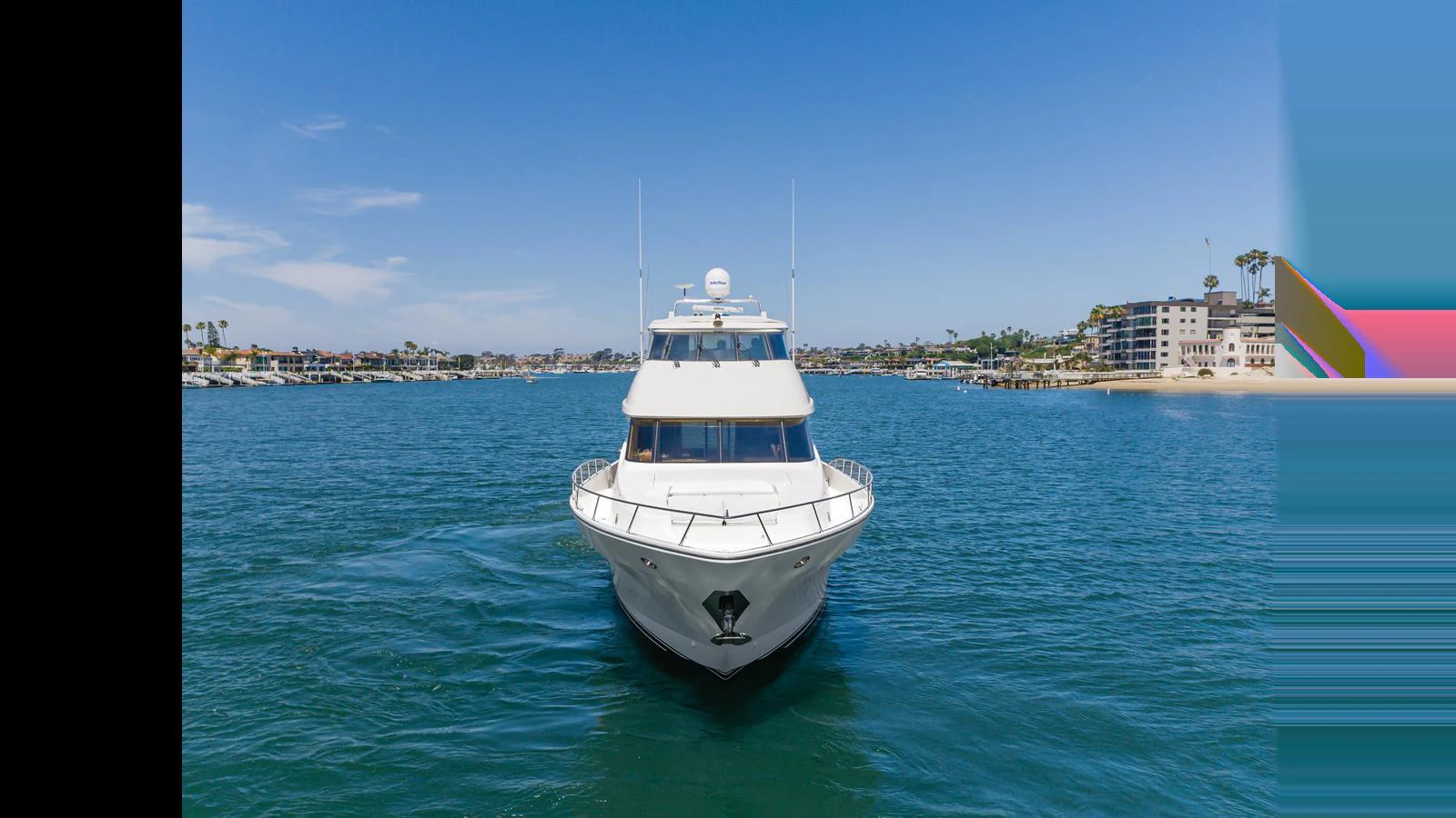 A sleek yacht cruises through calm waters with a scenic coastal backdrop. aboard SEAQUEL Yacht for Sale