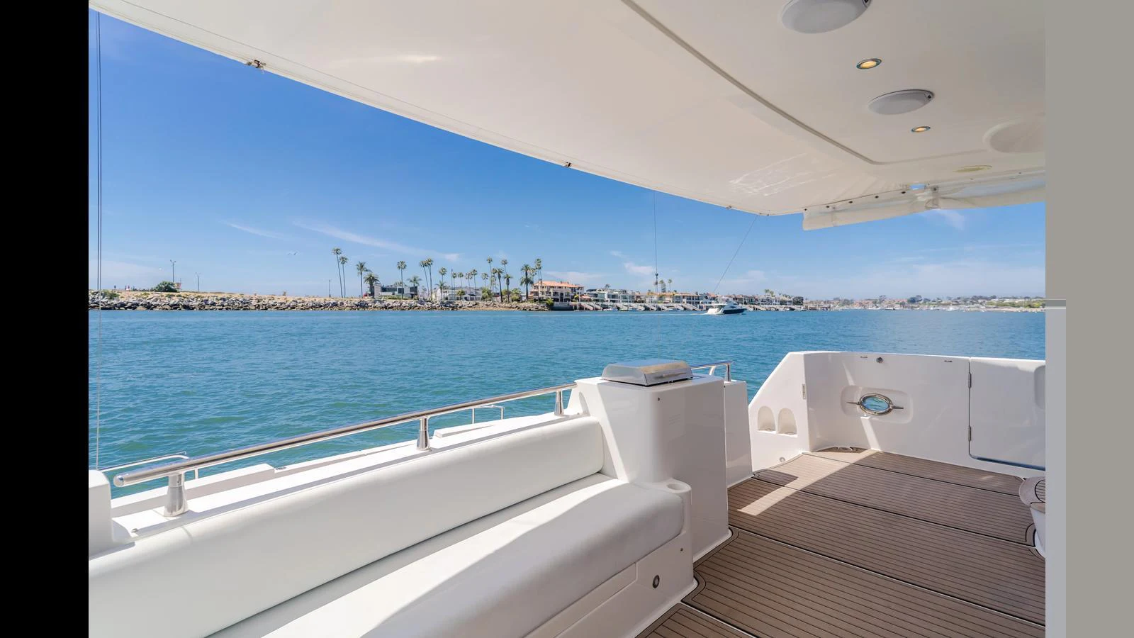 The aft deck offers a spacious and comfortable area with a scenic view of the water and shoreline. aboard SEAQUEL Yacht for Sale