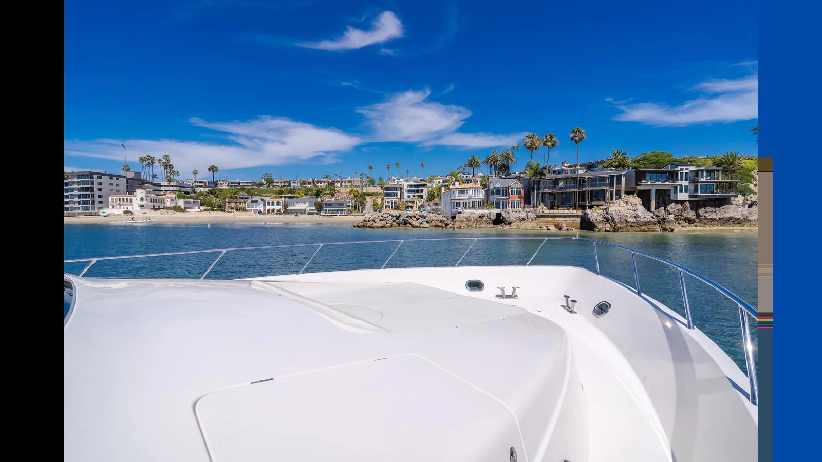 The yacht is anchored near a scenic coastal area with clear skies and calm waters. aboard SEAQUEL Yacht for Sale