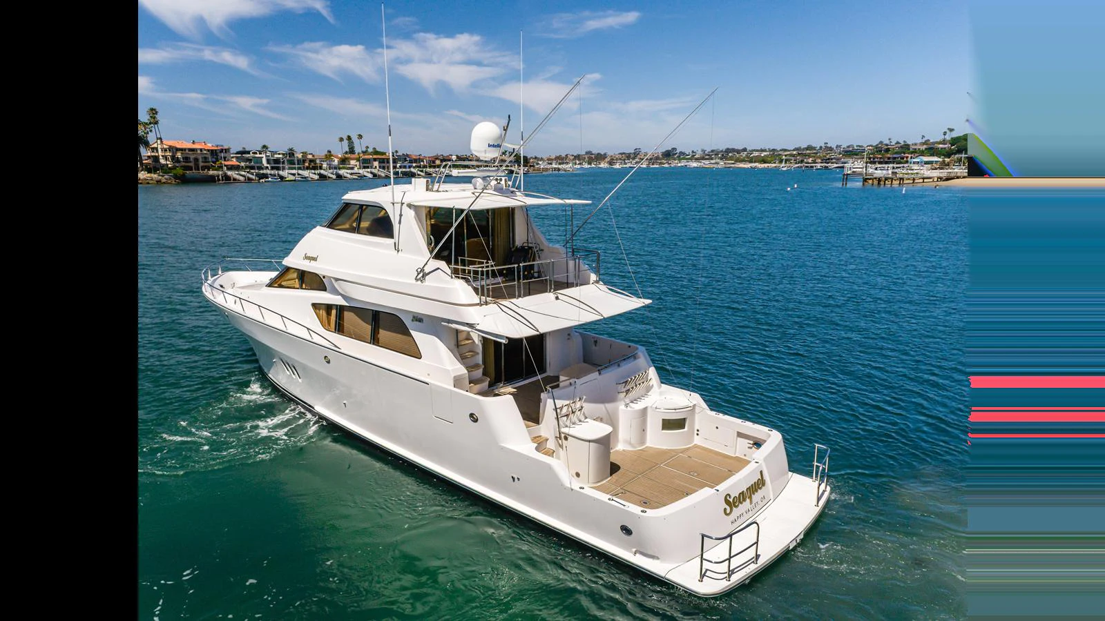 A sleek and elegant yacht cruising on calm blue waters under a clear sky. aboard SEAQUEL Yacht for Sale