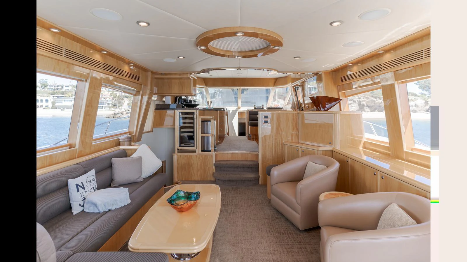 The salon features plush seating, large windows, and elegant wooden finishes, creating a luxurious and inviting space. aboard SEAQUEL Yacht for Sale