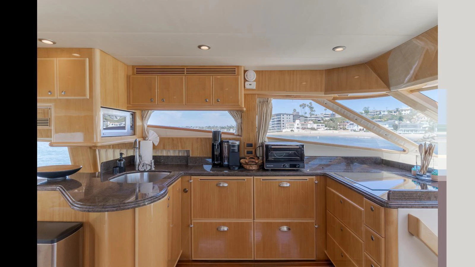 The yacht's galley features modern appliances and ample counter space with a panoramic view. aboard SEAQUEL Yacht for Sale