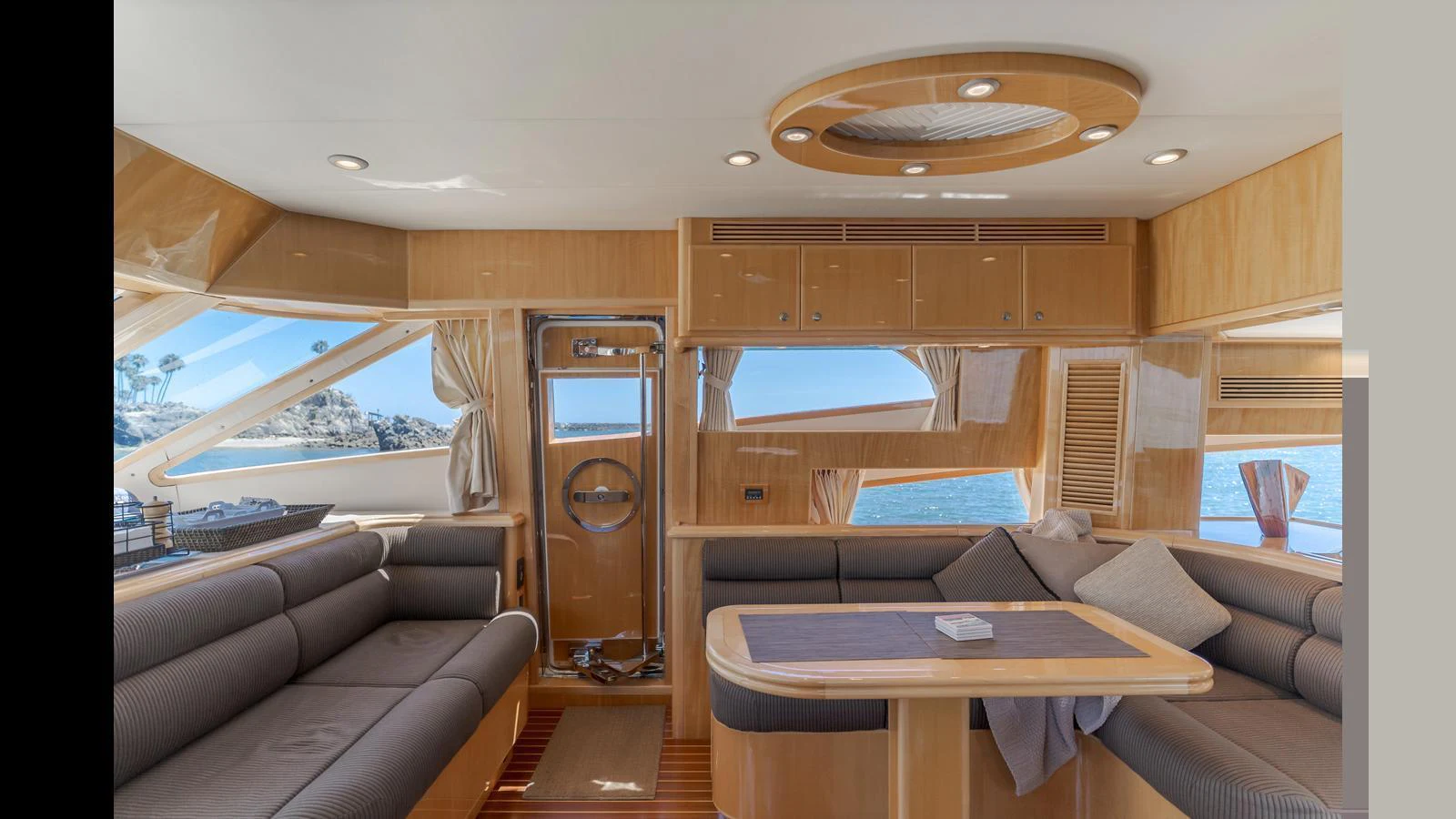 The salon features elegant wood finishes and comfortable seating with panoramic views. aboard SEAQUEL Yacht for Sale