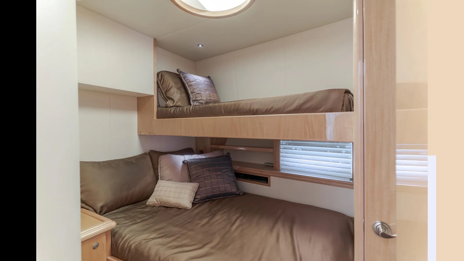 The guest cabin features a cozy bunk bed setup with elegant bedding and soft lighting. aboard SEAQUEL Yacht for Sale