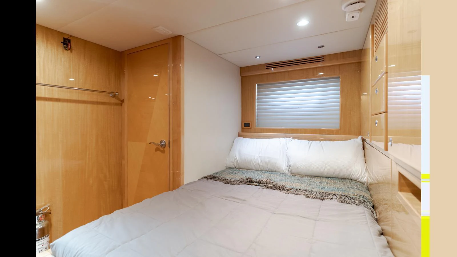 A cozy stateroom featuring a comfortable bed and warm wood finishes. aboard SEAQUEL Yacht for Sale