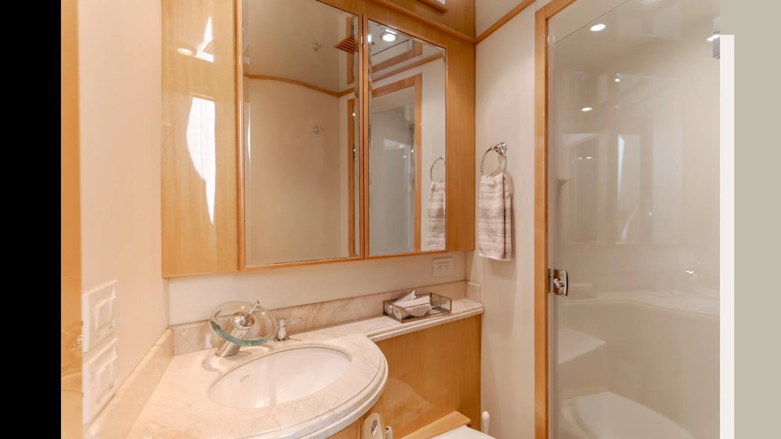 The yacht's bathroom features a sleek design with a modern sink and ample mirror space. aboard SEAQUEL Yacht for Sale