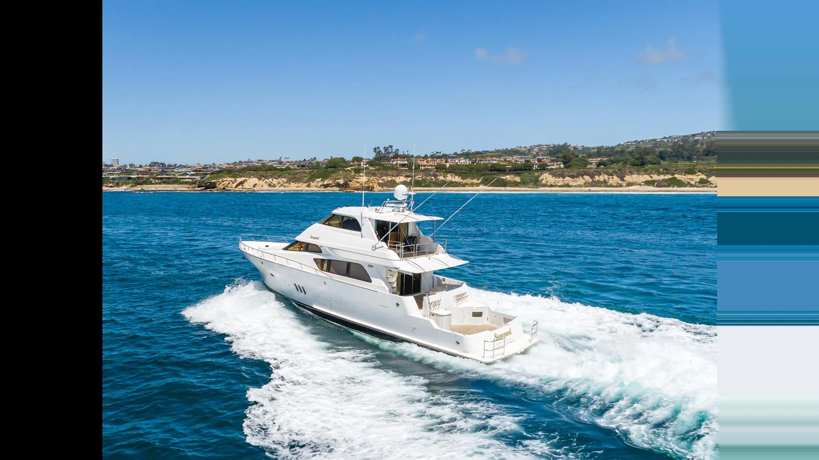 A sleek yacht cruises through clear blue waters near a scenic coastline. aboard SEAQUEL Yacht for Sale
