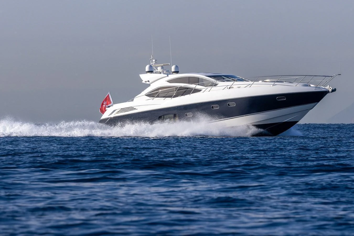 A sleek yacht cruises swiftly across the open water, showcasing its modern design and powerful performance. aboard M/Y MIEL Yacht for Sale