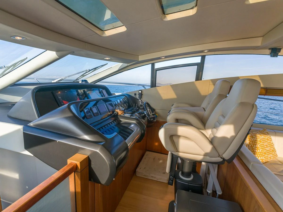 The helm station features luxurious seating and state-of-the-art navigation equipment, bathed in natural light from overhead skylights. aboard M/Y MIEL Yacht for Sale