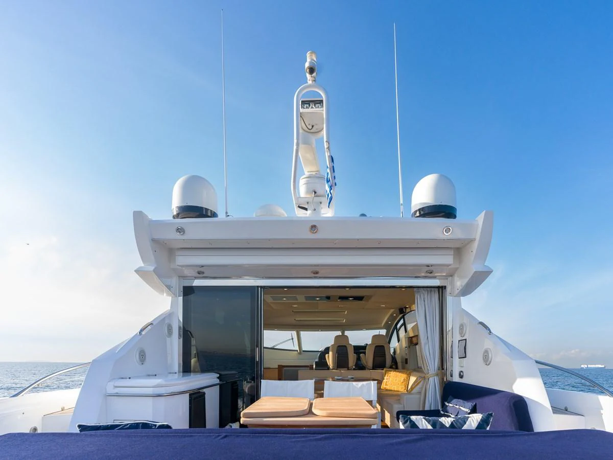The aft deck of the yacht features a spacious lounging area with a view into the interior. aboard M/Y MIEL Yacht for Sale