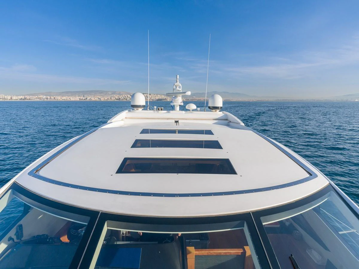 The yacht's sleek exterior showcases its modern design and expansive windows, set against a serene ocean backdrop. aboard M/Y MIEL Yacht for Sale