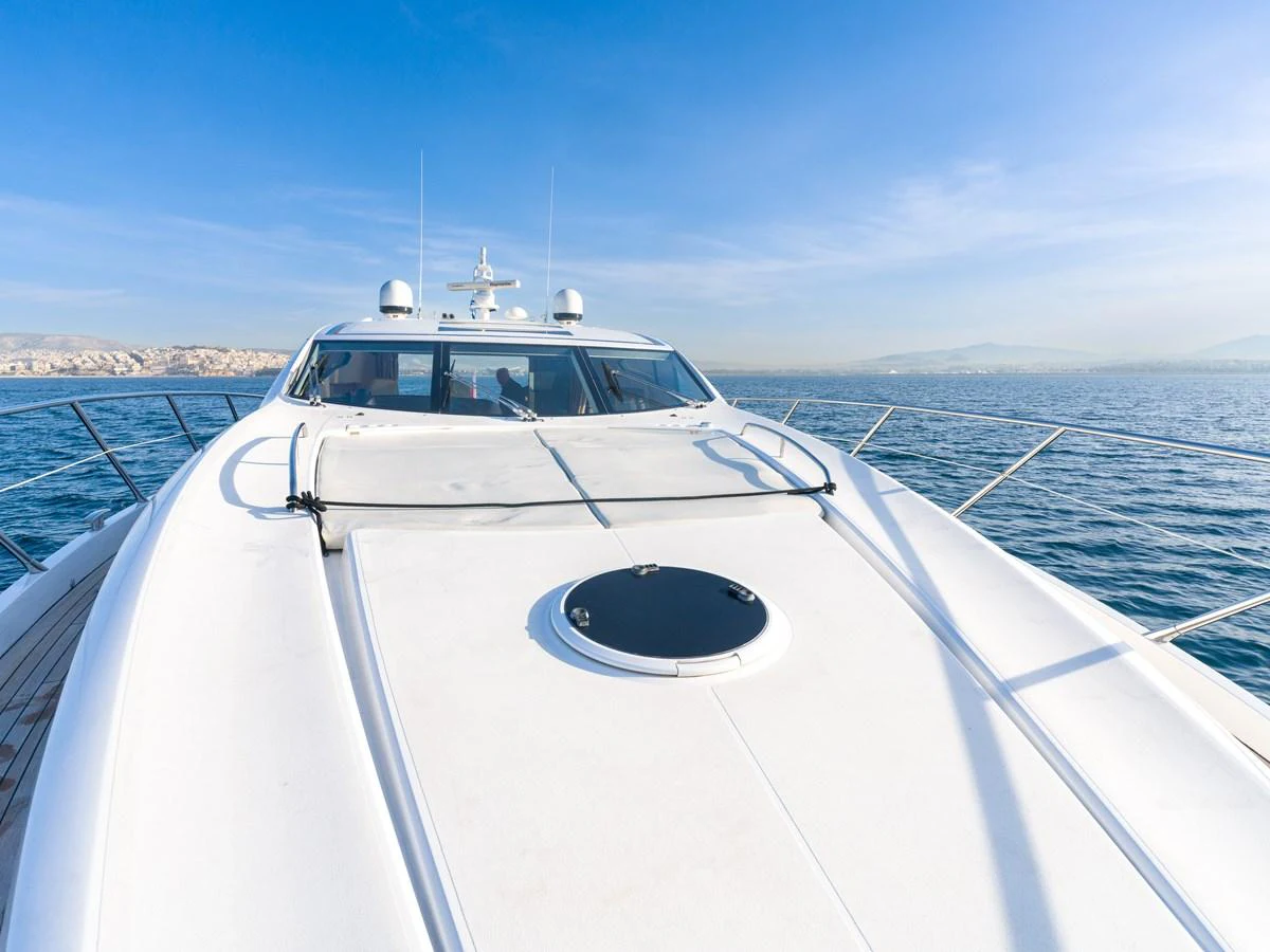 The yacht's sleek exterior deck offers a stunning view of the open sea under a clear blue sky. aboard M/Y MIEL Yacht for Sale