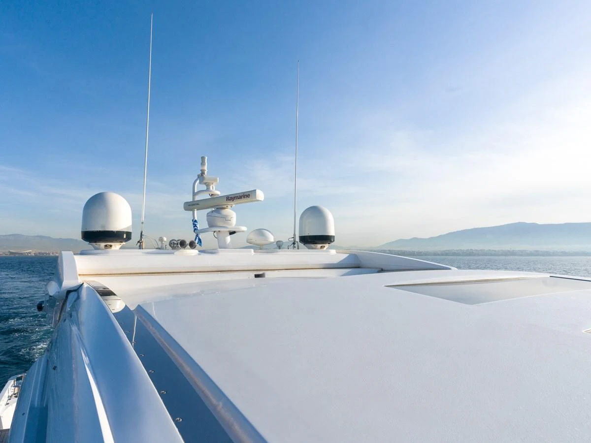 A close-up view of the yacht's upper deck showcasing navigational equipment against a clear sky. aboard M/Y MIEL Yacht for Sale
