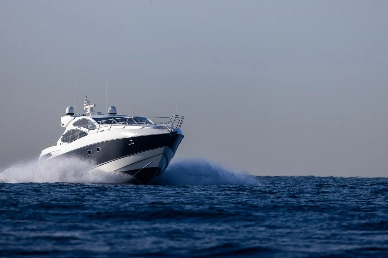 A sleek yacht cruises swiftly over the open water, showcasing its powerful design. aboard M/Y MIEL Yacht for Sale
