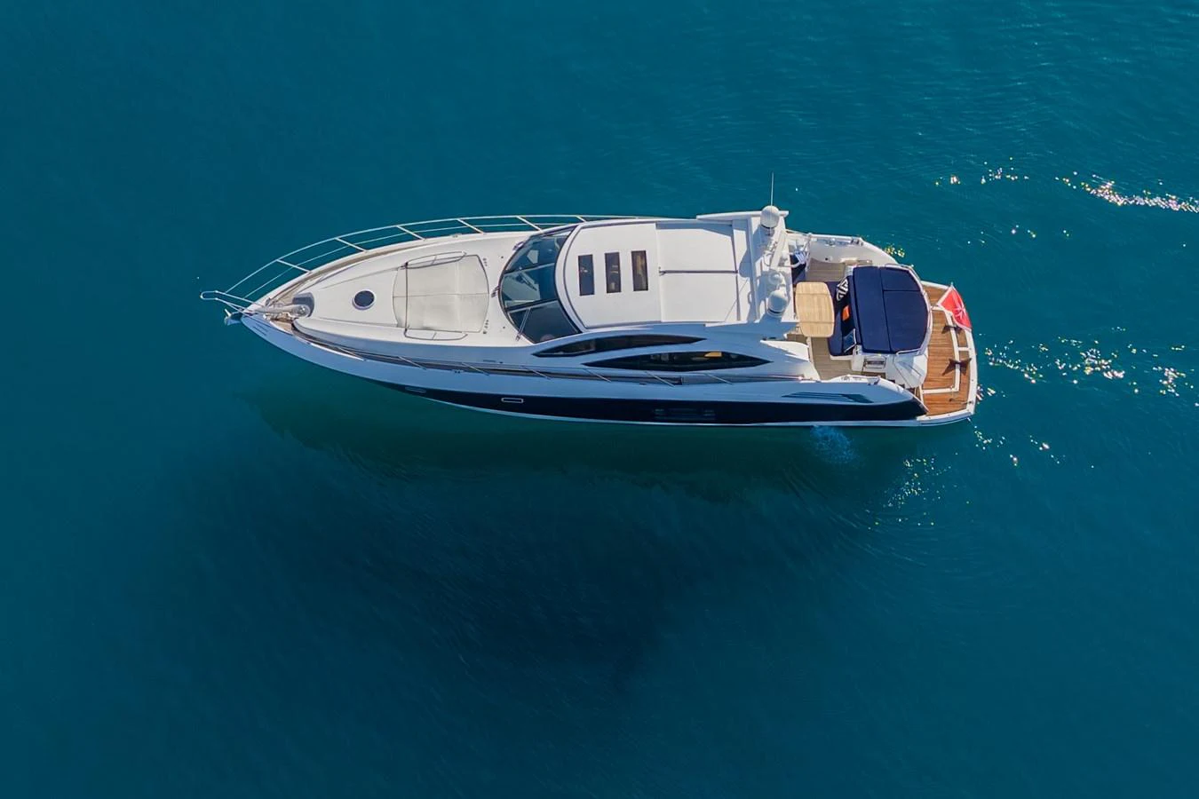 A sleek and modern yacht glides gracefully over calm blue waters. aboard M/Y MIEL Yacht for Sale