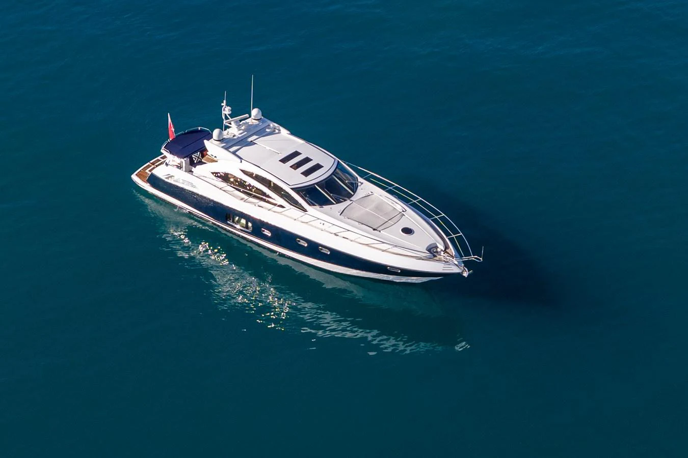 A sleek and modern yacht glides gracefully on the open water, showcasing its elegant design. aboard M/Y MIEL Yacht for Sale
