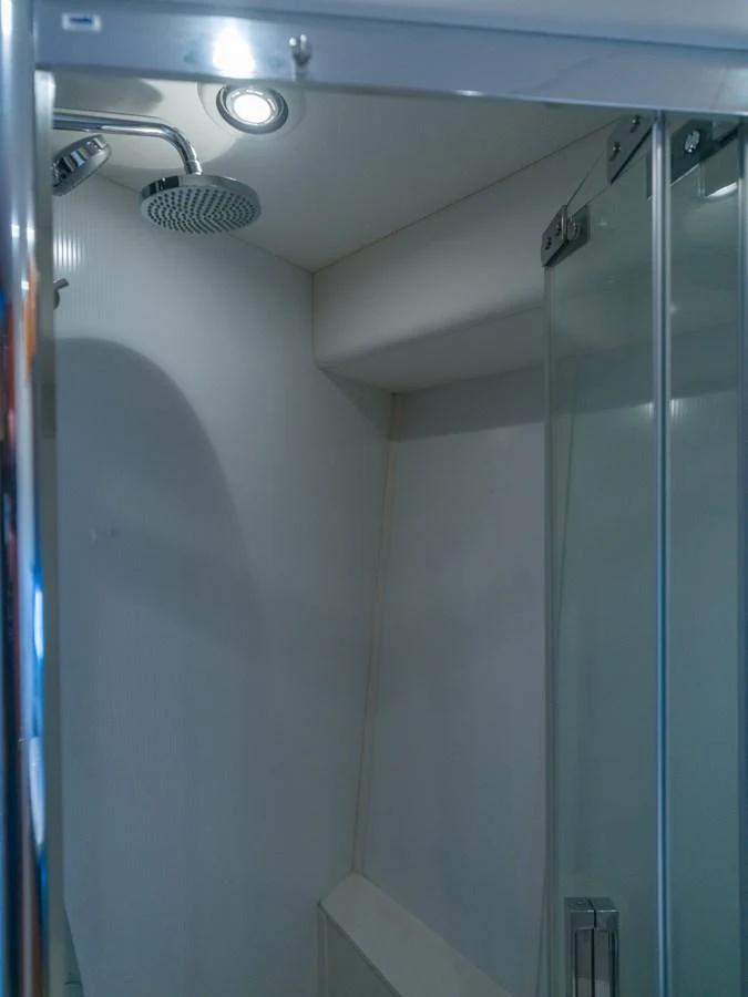 The yacht features a modern shower with a glass door and overhead rain showerhead. aboard M/Y MIEL Yacht for Sale