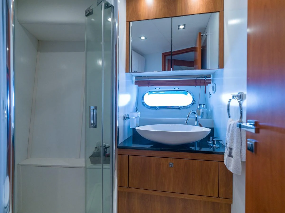 The yacht's bathroom features a sleek design with a glass-enclosed shower and modern fixtures. aboard M/Y MIEL Yacht for Sale