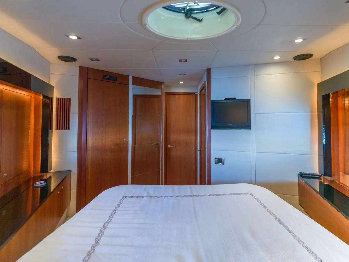 The stateroom offers a cozy and elegant retreat with warm wood finishes and modern amenities. aboard M/Y MIEL Yacht for Sale